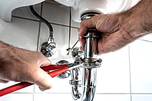 plumber taking apart drain